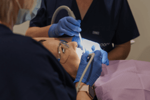 A close up of a person having fissure sealants applied to reduce tooth decay by a dental hygienist in Christchurch