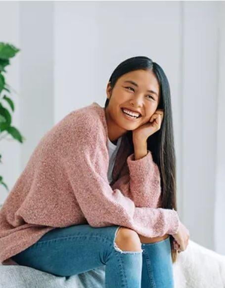 Girl sitting on sofa smiling